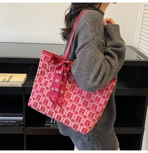 Detail of red wedding tote bag with double happiness pattern and ribbon bow decor
