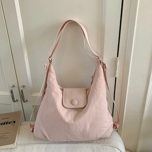 Detail view of pink tote bag with adjustable strap and magnetic flap closure system