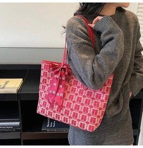 Detail of red festive tote bag with double happiness jacquard and silk bow ribbon