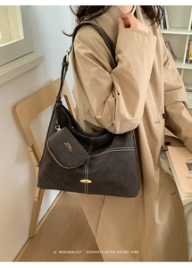 Detail view of large brown vintage tote bag with contrast stitching and small coin purse