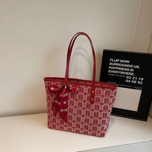 Detail of red and beige tote bag with Double Happiness jacquard and silk bow ribbon