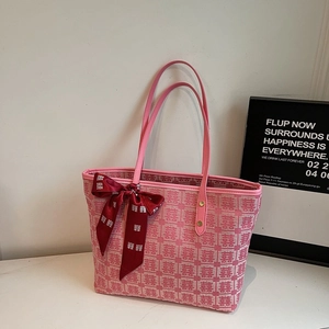 Close-up of pink festive tote bag with red Double Happiness patterns and silk bow detail