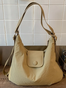 Vintage khaki nylon tote bag with pleated texture and adjustable strap for women