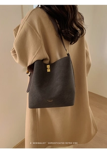 Détail du sac seau en cuir mat avec fermoir métallique et logo Pan'tor London