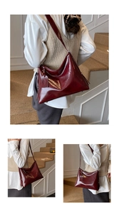 Detail view of burgundy faux leather tote bag with glossy wrinkled texture on wooden stairs