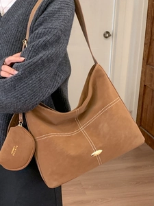 Brown suede hobo tote bag with white stitching and round coin purse for winter fashion