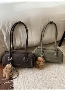 Detail of retro suede Boston bags in coffee and green with cute puppy charms