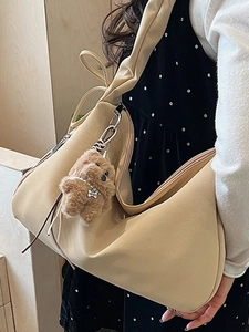 Minimalist beige pleated cloud shoulder bag for women with a cute plush bear pendant accessory
