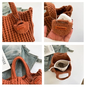 Detail view of burnt orange knit tote bag with handmade charm and canvas drawstring liner