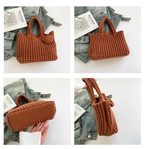 Detail view of caramel knitted tote bag with chunky lattice weave and heart charm