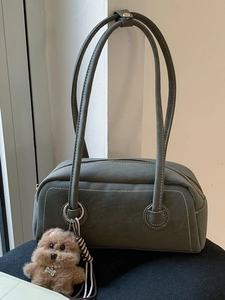 Vintage suede Boston bag in olive green with decorative stitching and plush bear charm