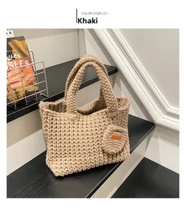 Close-up of khaki handmade knit tote bag with mesh texture and matching charm