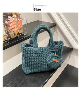 Detail of blue chunky knit tote bag with handmade label and mini round coin purse