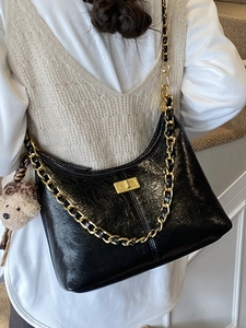 Chic black glossy hobo bag with gold chain strap and cute leopard bear charm