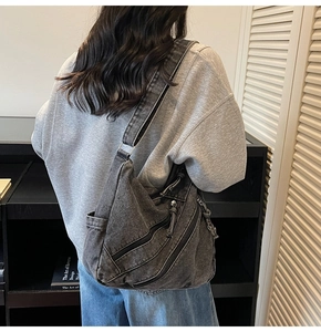 Detailed back view of charcoal grey washed denim tote bag with multiple zippers