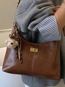 Brown vintage pleated shoulder bag with gold clasp and cute plush bear charm