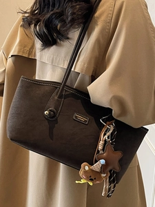 Chic dark brown faux suede tote bag with contrast stitching and decorative charms