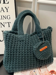 Minimalist dark green hand-knitted tote bag with matching coin purse and handmade label