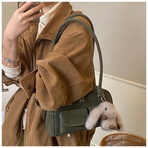 Mirror selfie showing dark green vintage handbag with a cute plush rabbit charm