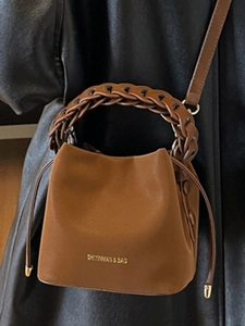 Chic brown leather bucket bag with woven handle and drawstring closure for women
