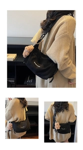 Detail of black canvas tote with bear charm and Banatu lettering on shoulder