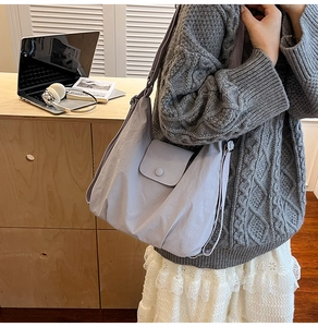 Detail of lilac crescent tote with front flap pocket and adjustable wide strap