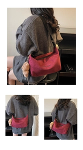 Detail showing Burgundy suede crescent bag with adjustable strap and plush bear charm