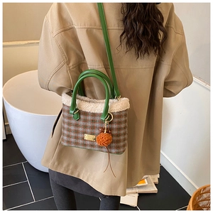 Detailansicht der Retro-Plüschtasche mit Karomuster, Fleecebesatz und Pelzanhänger