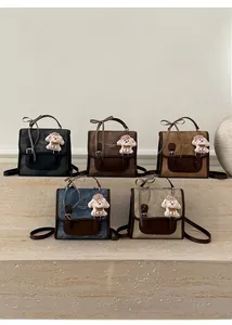 Multiple vintage backpacks in five colors displayed on steps with cute teddy pendants
