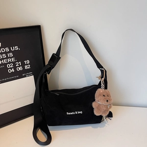 Detail of black corduroy tote bag with Banatu & bag logo and cute brown plush bear charm