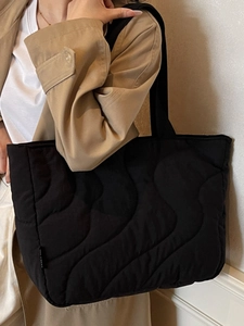 Lightweight black quilted tote bag with wave pattern stitching and large capacity