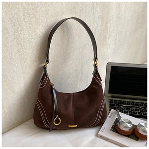 Detail view of coffee brown hobo bag with white stitching and gold metal hardware