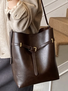 Minimalist large capacity dark brown leather bucket bag with gold buckle on shoulder
