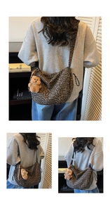 Detailed leopard print shoulder bag featuring a crescent shape and plush bear charm decoration