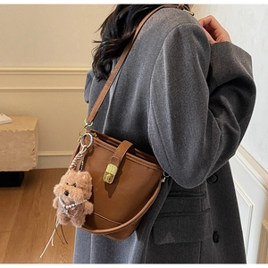Sac seau marron avec fermoir rotatif doré et charmant pendentif en forme d'ours