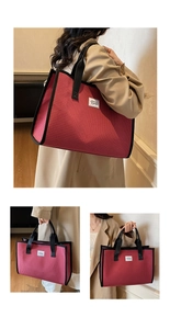 Detailed close-up of a large red checkerboard tote bag with black handles and a brand label