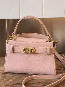 Pink faux suede crossbody bag with gold hardware and adjustable strap for women