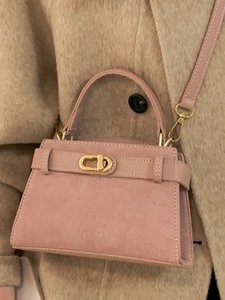 Pink suede patchwork crossbody bag with gold twist lock and adjustable shoulder strap