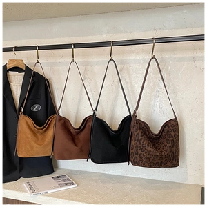 Collection of minimalist suede tote bags in brown, black, and leopard print styles