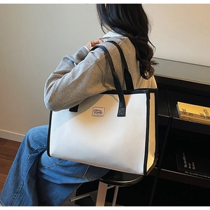 Detail shot of a large minimalist tote bag with Memory Bags label and contrast trim