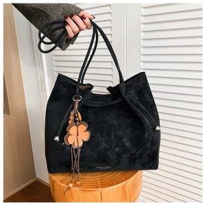 Detail of black suede tote bag featuring a floral vintage charm and GOIILSON logo
