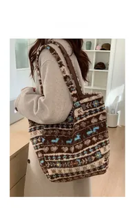 Model display of a fuzzy plush tote bag with Nordic pattern and leather shoulder strap