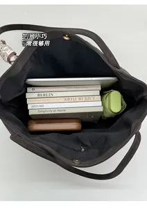 Top-down view of spacious tote interior with tablet, books, and daily essentials