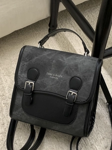 Vintage dark gray college backpack with black leather straps and buckle detailing
