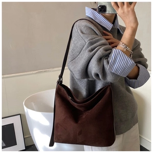 Mirror selfie showing the large brown suede hobo bag with sleek leather strap and zipper