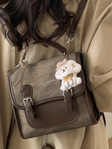 Retro brown women's crossbody bag with plush dog charm and stylish checkered ribbon