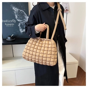 Quilted khaki tote bag featuring puffy square texture and detachable shoulder strap