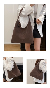 Close-up of deep brown suede shoulder bag with high-quality matte leather texture