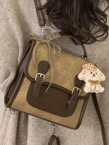 Vintage color-block messenger bag with plaid bow and plush dog charm on model