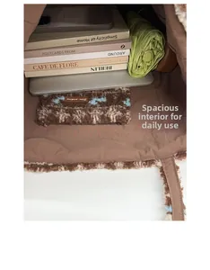 Spacious interior of brown plush tote bag holding a laptop, books, and an umbrella